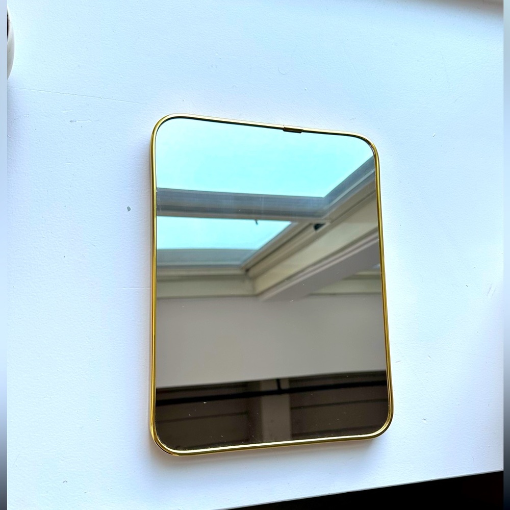 Gold trim vanity mirror. Great for hanging or table top. Comes with stand.